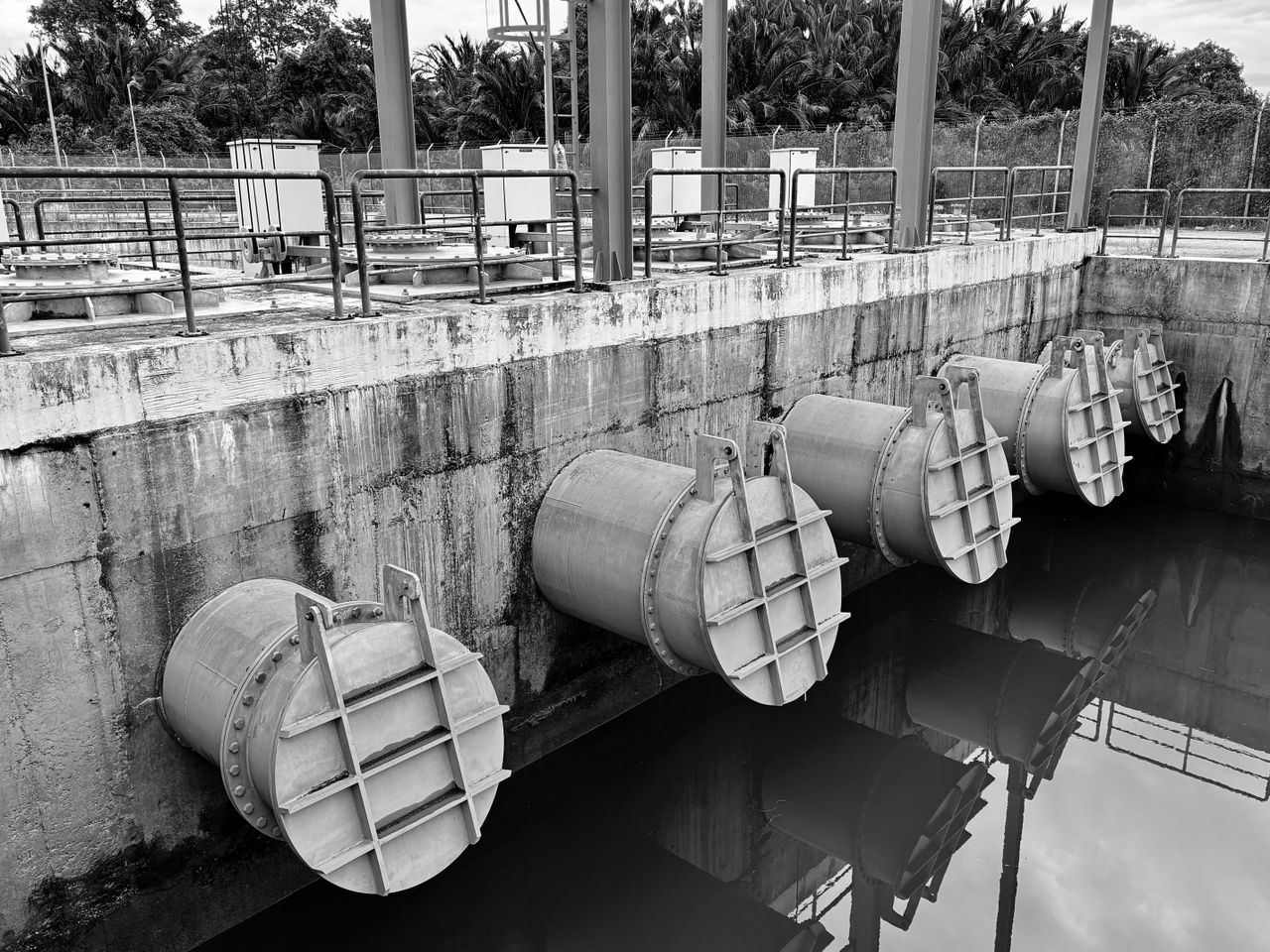 Mastering the First Impression: Your intriguing post title goes here Monochrome image of large industrial water pipes with valves.